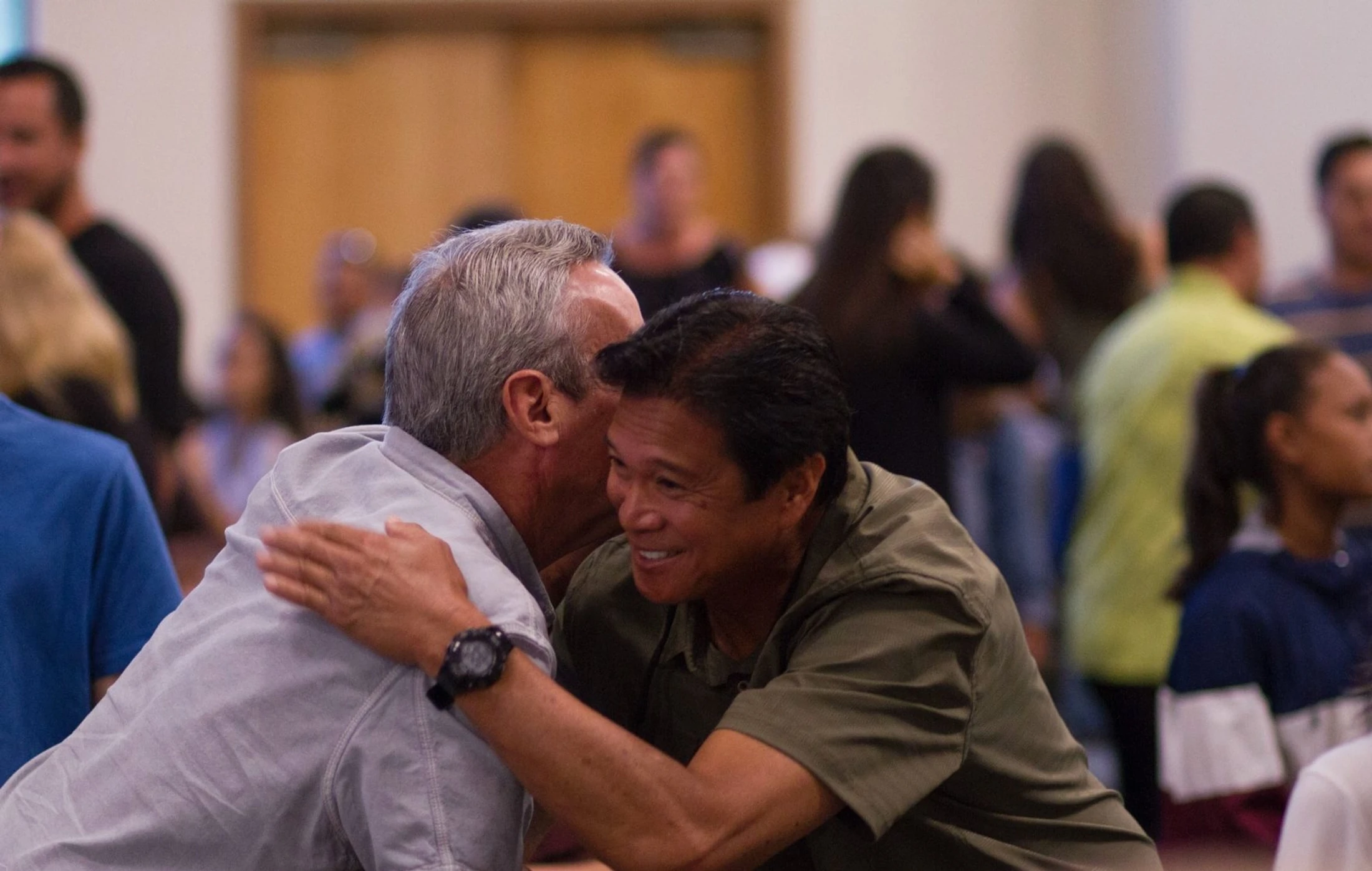 Two men embracing at a New Life men’s gathering