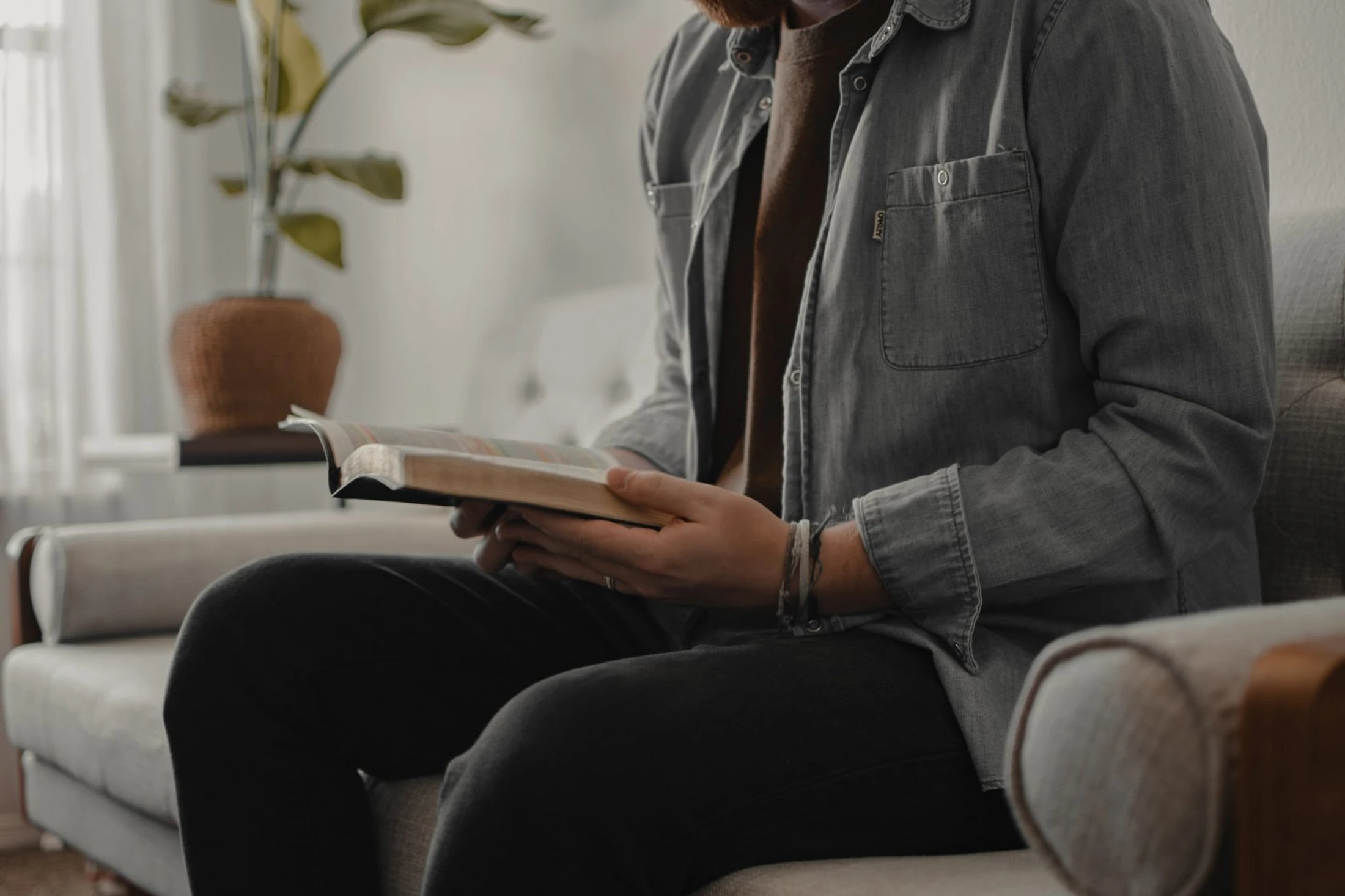 A person reading an open Bible at home